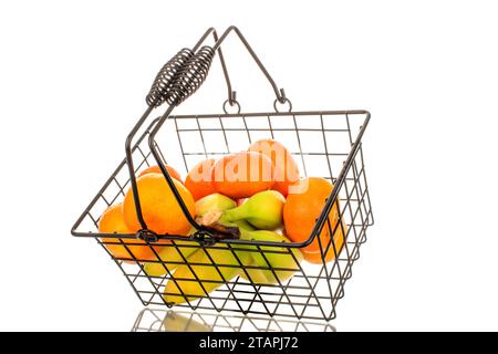 Several ripe bright yellow bananas and tangerines in a basket, macro, isolated on white background. Stock Photo