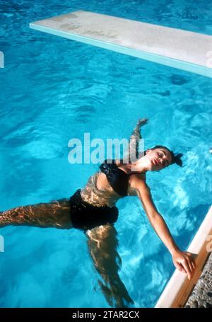 LAS VEGAS, NV - 1958: Actress and model Kitty Dolan relaxes in the pool circa 1958 in Las Vegas, Nevada. (Photo by Hy Peskin) *** Local Caption *** Kitty Dolan Stock Photo