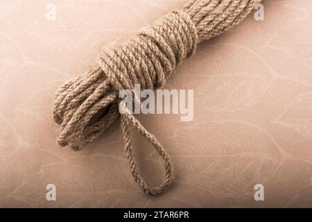 Bundle of linen rope in a sbrown background Stock Photo - Alamy