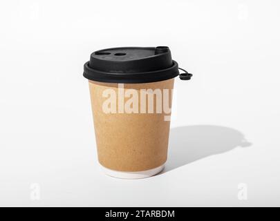 Take-away paper cup mockup, coffee mug mock-up. Take-away brown drink container for hot beverage with black cap Stock Photo
