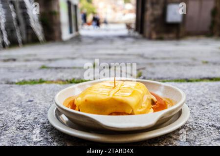 Great view of francesinha typical dish originally from Porto, made with layers of toasted bread and assorted hot meats such as roast, steak Stock Photo