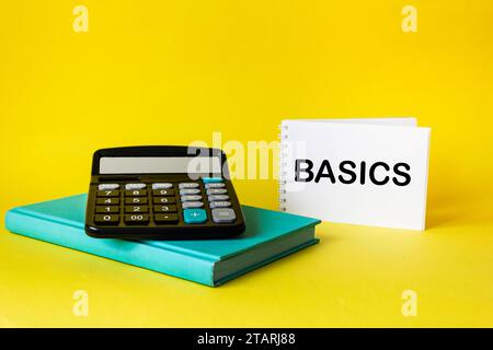 The word BASICS written on a notepad and yellow background Stock Photo