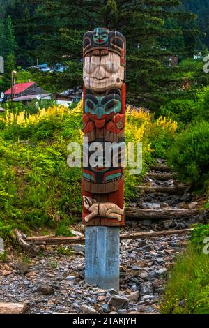Hoonah, Icy Strait Point, Alaska USA-06/29/2019: Small totem pole next to the walking path near downtown. Stock Photo