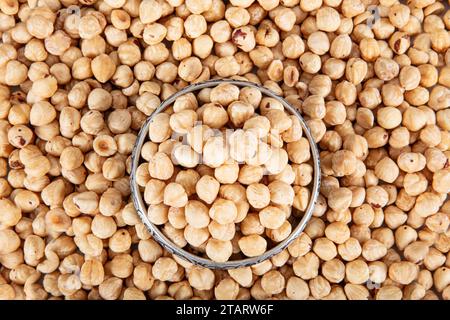 Pile of roasted nuts on white background. Hazelnuts harvest. Filbert photo wallpaper. Full frame of hazel. Peeled brown nut kernels. Healthy organic b Stock Photo