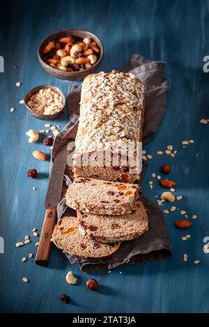Delicious delicacies bread with raisins, nuts and dried fruits. Bread with raisins, nuts and bran. Stock Photo