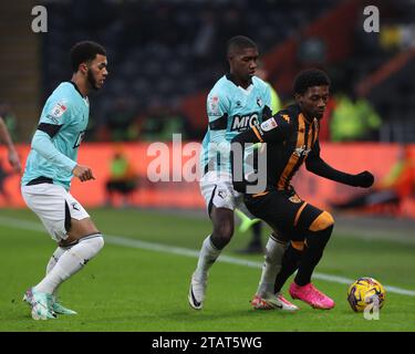 Hull City's Jaden Philogene-Bidace in action with Watford's Yaser Asprilla (r) and Jamal Lewis during the Sky Bet Championship match between Hull City and Watford at the MKM Stadium, Kingston upon Hull on Saturday 2nd December 2023. (Photo: Mark Fletcher | MI News) Credit: MI News & Sport /Alamy Live News Stock Photo
