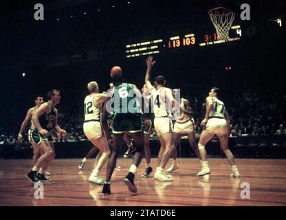 NEW YORK, NY- OCTOBER 25:  Bob Cousy #14 of the Boston Celtics goes for the hook shot as Charlie Tyra #14 and Kenny Sears #12 of the New York Knicks defend during an NBA game on October 25, 1958 at the Madison Square Garden in New York, New York.  (Photo by Hy Peskin)  *** Local Caption *** Kenny Sears;Bob Cousy;Charlie Tyra;Bill Russell Stock Photo
