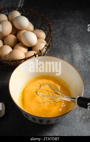 Whisk eggs in bowl Stock Photo
