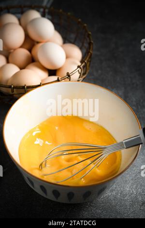 Whisk eggs in bowl Stock Photo
