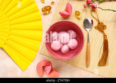 Bowl of tangyuan, fortune cookies, Chinese decor and sakura on pink ...