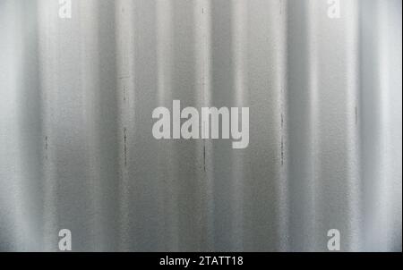 A sheet of grey corrugated iron has a mark on one of its ridges Stock Photo