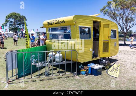 Australia Christmas market in Narrabeen Sydney, yellow caravan cooking crepes as takeaway fast food for shoppers,NSW,Australia Stock Photo