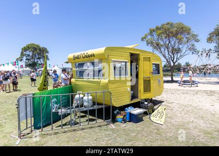 Australia Christmas market in Narrabeen Sydney, yellow caravan cooking crepes as takeaway fast food for shoppers,NSW,Australia Stock Photo