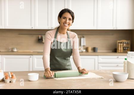 Happy beautiful female baker woman in apron home portrait Stock Photo