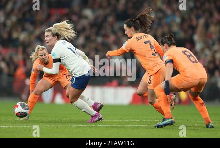 London, UK. 1st Dec, 2023. Lauren Hemp of England avoids a challenged from Caitlin Dijkstra (2nd R) of the Netherlands during the UEFA Women's Nations League match at Wembley Stadium, London. Picture credit should read: Paul Terry/Sportimage Credit: Sportimage Ltd/Alamy Live News Stock Photo