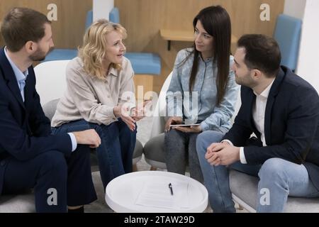 Boss conduct briefing with employees in modern co-working office Stock Photo