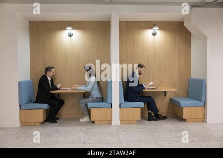 Group of diverse businesspeople working seated in modern co-working office Stock Photo
