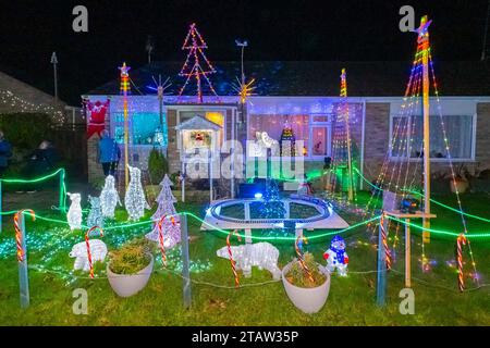 Bridport, Dorset, UK.  1st December 2023.  Actor Martin Clunes switches on the annual display of Christmas Lights which decorate the house of Monica and Rob Teague at White Close at Bradpole in Bridport, Dorset.  The display raises money for Julia’s House Children’s Hospice.  The light display outside the front of the house.  Picture Credit: Graham Hunt/Alamy Live News Stock Photo