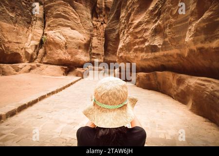 Tourists in Petra take photograph of The Siq, the narrow slot-canyon that serves as the entrance passage to the hidden city of Petra, Jordan Stock Photo