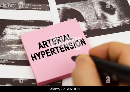 Medical concept. On the ultrasound pictures there are stickers that say - arterial hypertension Stock Photo