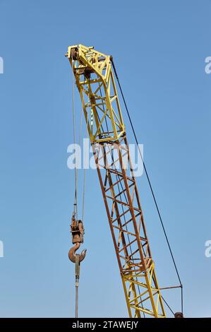 Detail from a floading cargo crane over blue sky background. Boom crane part of mobile crane using to heavy lifting and move object in many industry s Stock Photo