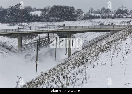 Coburg, Germany. December 3rd, 2023 Coburg, Germany. Steam rises on railway tracks as a German train approaches a tunnel outside the city of Coburg. There have been many cancellations of both rail and airline services in Bavaria today due to bad weather. Photo: Clearpiximages / Alamy Live News Stock Photo