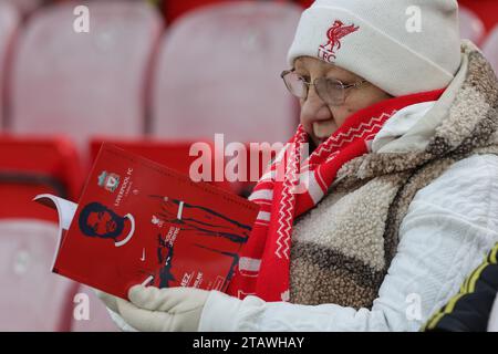 Liverpool, UK. 03rd Dec, 2023. A Liverpool fan reads the match day programme ahead of the Premier League match Liverpool vs Fulham at Anfield, Liverpool, United Kingdom, 3rd December 2023 (Photo by Mark Cosgrove/News Images) Credit: News Images LTD/Alamy Live News Stock Photo