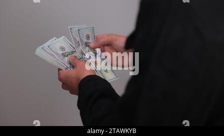 American dollars or US dollars: hands counting one hundred American money or 100 USD. Stock Photo