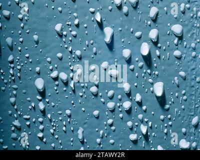 Water droplets against blue background Stock Photo