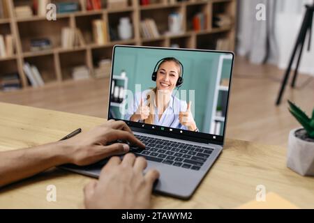 Arab guy using laptop, have online meeting with consultant Stock Photo
