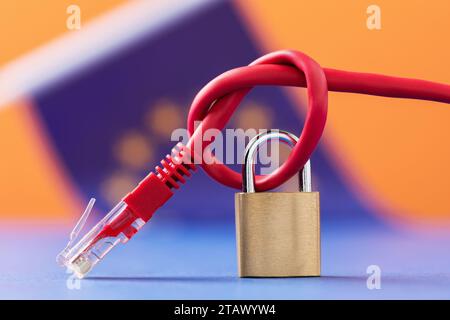 A closed padlock on a tied network wire against the background of the European Union flag, a concept on the topic of security of Internet technologies Stock Photo
