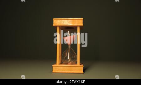 Hourglass against dark background | sandglass, sand timer, or sand clock Stock Photo