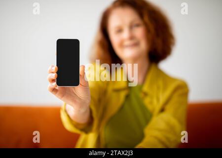 Blank Smartphone With Black Screen In Hand Of Senior Woman Stock Photo