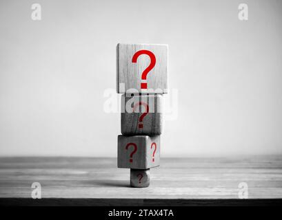 Unresolved issues, stress accumulation at work, difficult problem, health problems, burnout, high workload. Red question mark symbols on cube block st Stock Photo