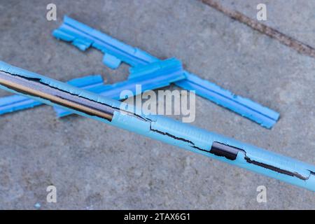 Plastic covering a broom handle disintegrating and peeling off Stock Photo