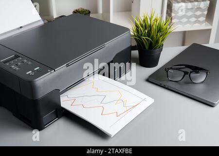 New modern printer and laptop in the office on table Stock Photo