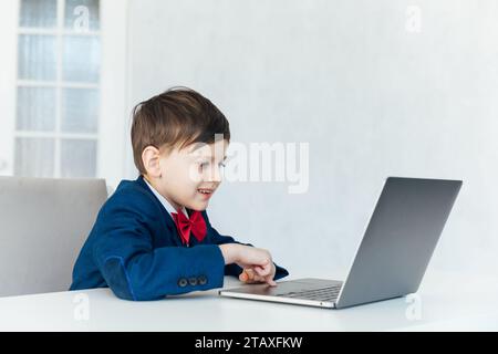 pupil lessons education boy schoolboy learns at the computer online school in the classroom Stock Photo
