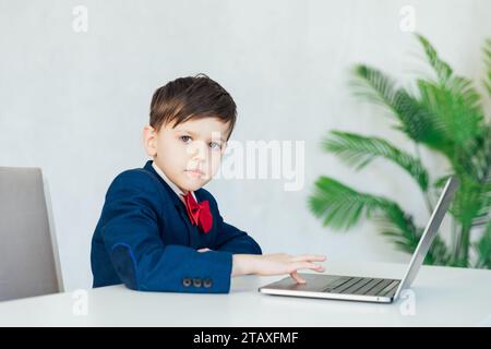 pupil lessons education boy schoolboy learns at the computer online school in the classroom Stock Photo