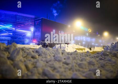 Augsburg, Germany. 03rd Dec, 2023. Soccer: Bundesliga, FC Augsburg - Eintracht Frankfurt, Matchday 13, WWK Arena. Spectators walk between mountains of snow to the WWK Arena. Credit: Tom Weller/dpa - IMPORTANT NOTE: In accordance with the regulations of the DFL German Football League and the DFB German Football Association, it is prohibited to utilize or have utilized photographs taken in the stadium and/or of the match in the form of sequential images and/or video-like photo series./dpa/Alamy Live News Stock Photo