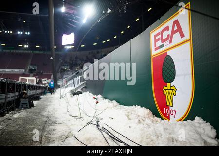 Augsburg, Germany. 03rd Dec, 2023. Soccer: Bundesliga, FC Augsburg - Eintracht Frankfurt, Matchday 13, WWK-Arena. Cleared snow lies behind the advertising boards. Credit: Tom Weller/dpa - IMPORTANT NOTE: In accordance with the regulations of the DFL German Football League and the DFB German Football Association, it is prohibited to utilize or have utilized photographs taken in the stadium and/or of the match in the form of sequential images and/or video-like photo series./dpa/Alamy Live News Stock Photo