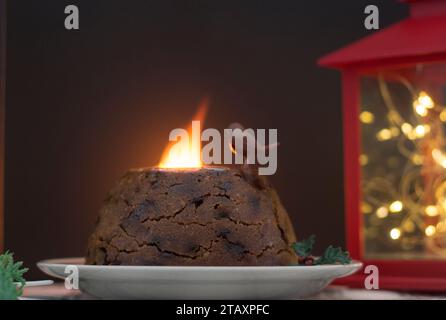 Festive Christmas pudding showing tradition of setting it on fire using brandy Stock Photo