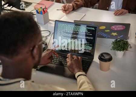Software developer producing efficient and elegant code, view over the shoulder Stock Photo