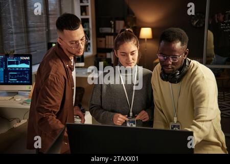 Software developer asking coworker to help him with fixing bug Stock Photo