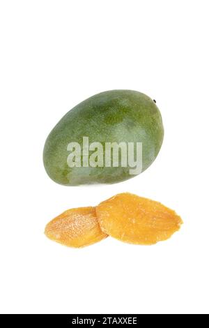 Two pieces of dried mango and a whole mango fruit on a white background. Copy space. Stock Photo