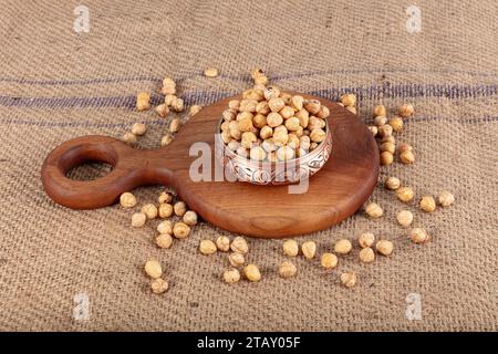 Hazelnut varieties in copper bowl on linen background. Roasted shelled hazelnuts, shelled hazelnuts and shellless roasted hazelnuts. Healthy food conc Stock Photo