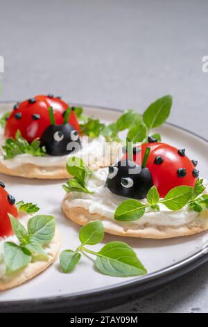 Lady bug cracker with cream cheese and tomato for summer party Stock Photo