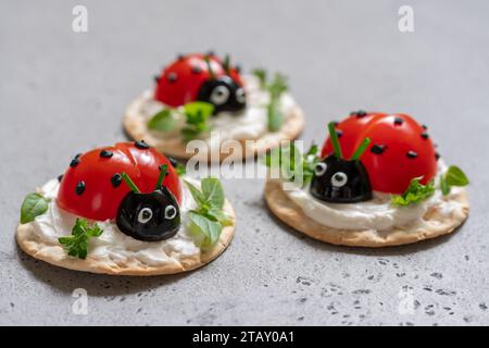 Lady bug cracker with cream cheese and tomato for summer party Stock Photo
