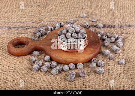 Hazelnut varieties in copper bowl on linen background. Roasted shelled hazelnuts, shelled hazelnuts and shellless roasted hazelnuts. Healthy food conc Stock Photo