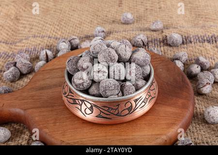 Hazelnut varieties in copper bowl on linen background. Roasted shelled hazelnuts, shelled hazelnuts and shellless roasted hazelnuts. Healthy food conc Stock Photo