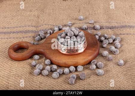 Hazelnut varieties in copper bowl on linen background. Roasted shelled hazelnuts, shelled hazelnuts and shellless roasted hazelnuts. Healthy food conc Stock Photo